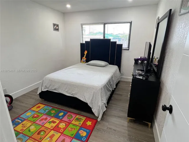 a bed sitting in a bedroom next to a window