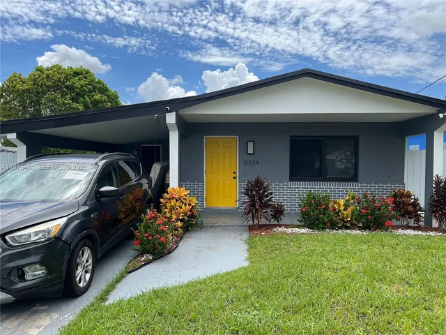 a front view of a house with lots of yellow lighting