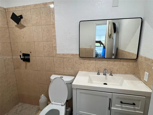 a bathroom with a sink mirror and toilet