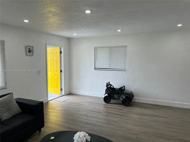 a room with wooden floor and a window