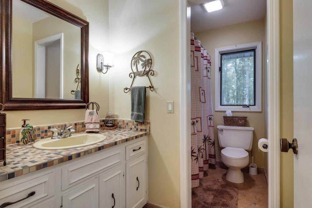 801 High Point Ridge Road Franklin, TN 37069 - Photo 23 of 29 a bathroom with a granite countertop sink a toilet and a mirror