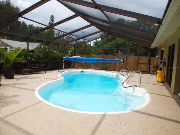 a view of a swimming pool with a patio