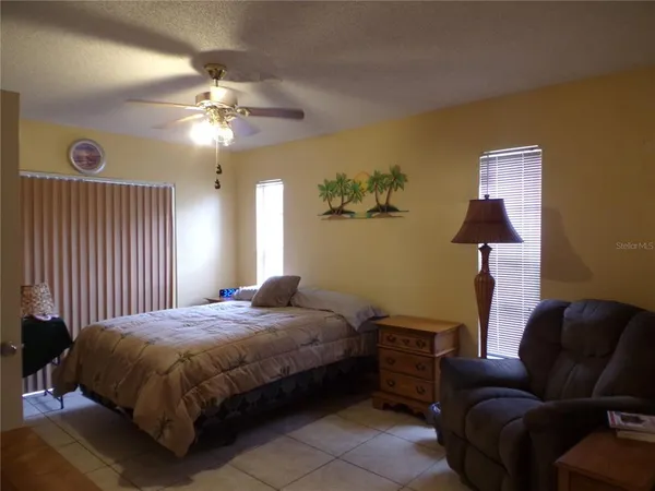 a bedroom with a bed couch and window