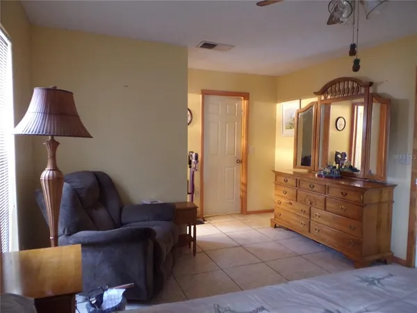 a living room with furniture a lamp and a chandelier