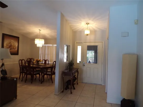 a view of a dining room with furniture and chandelier fan