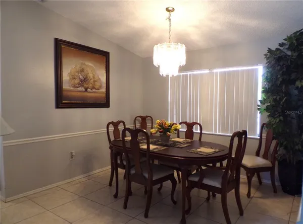 a view of a dining room with furniture wooden floor and a chandelier