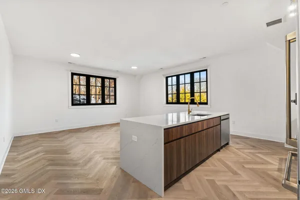 a view of a room with window and wooden floor