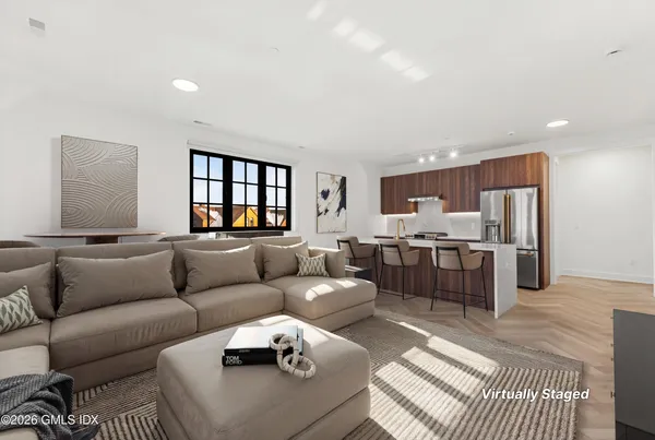 a living room with furniture and kitchen view