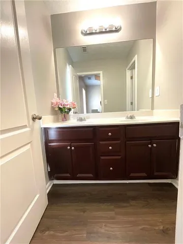 a bathroom with a sink vanity and mirror
