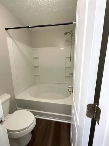 a bathroom with a toilet and a bathtub