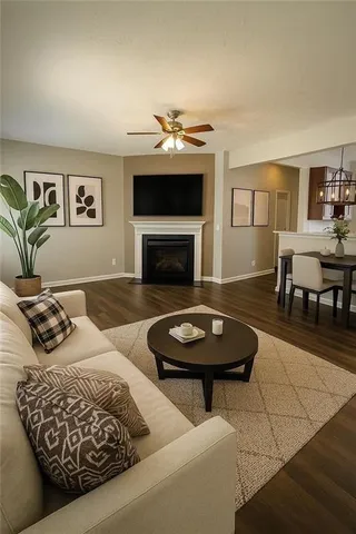 a living room with furniture a fireplace and a table