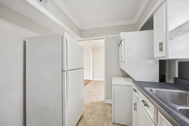 a kitchen with a refrigerator and a sink