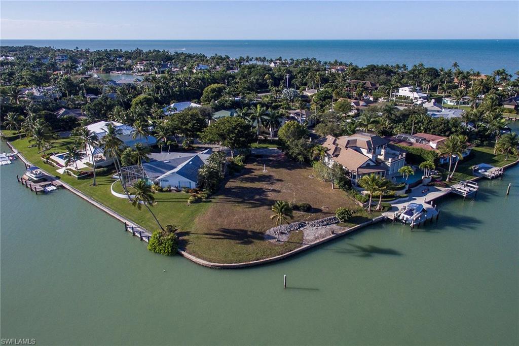 an aerial view of a house with a garden and lake view