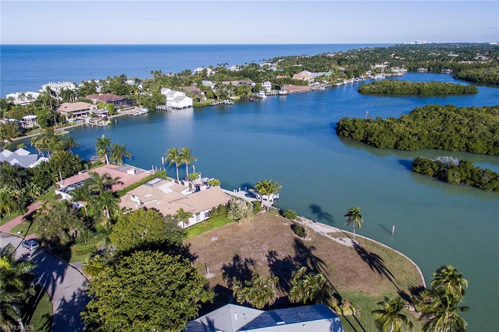 5 Sabre Lane Naples, FL 34102 - Photo 3 of 6 a aerial view of a house with a lake view