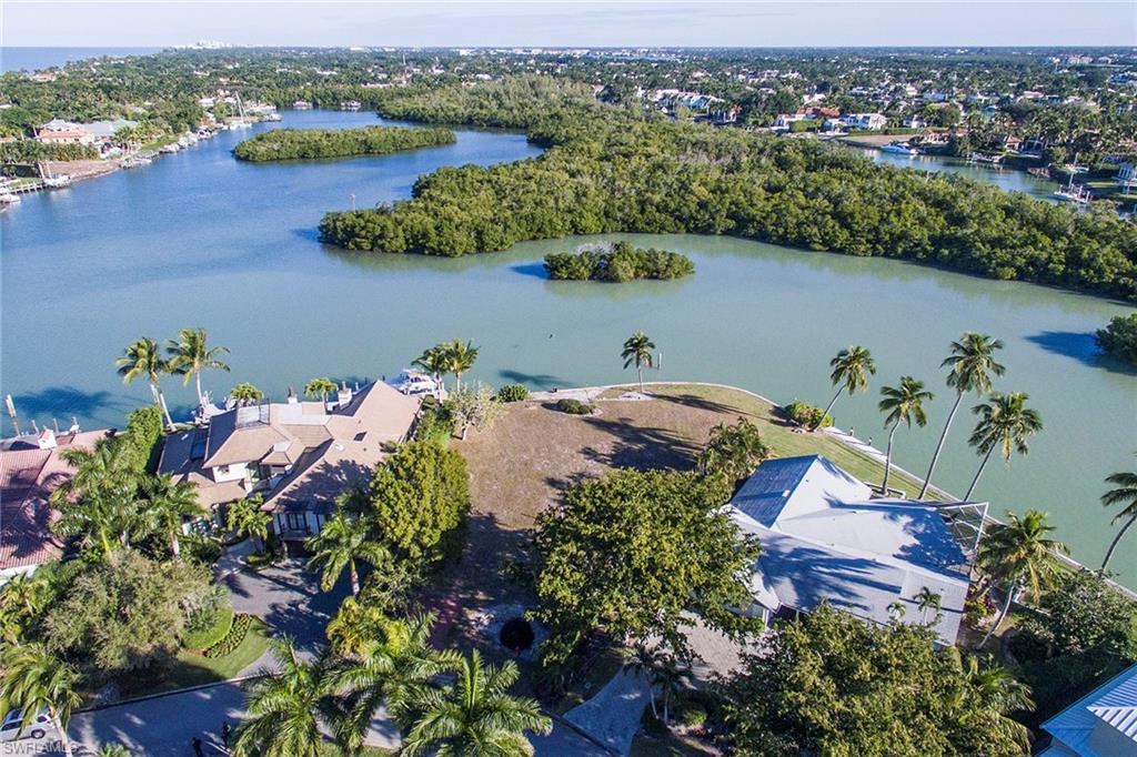 5 Sabre Lane Naples, FL 34102 - Photo 4 of 6 an aerial view of a houses with a lake