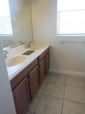 a kitchen with a sink cabinets and a window