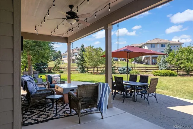 a view of a patio with furniture and a yard
