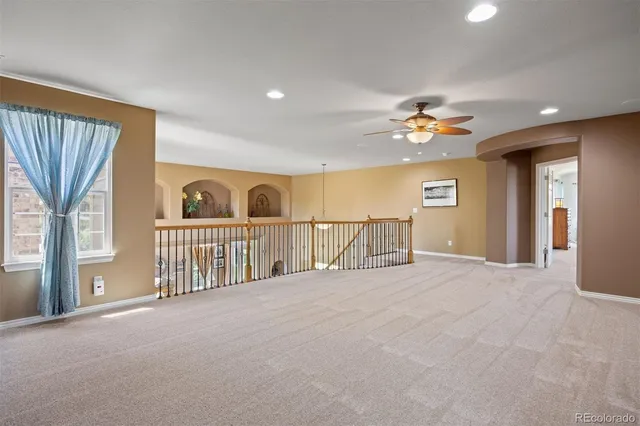 a view of a livingroom with a ceiling fan and window