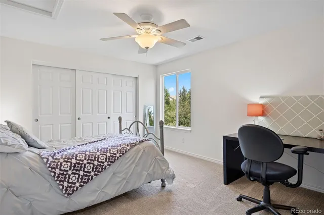 a bedroom with bed and a window