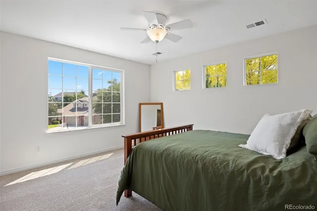 a bathroom with a sink a toilet a mirror and shower curtain