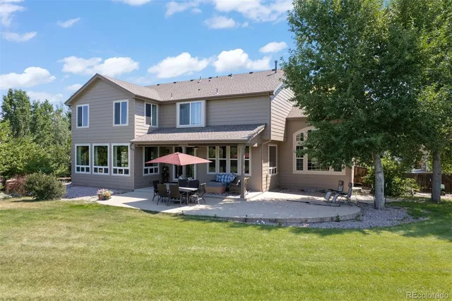 a view of a house with swimming pool and sitting area