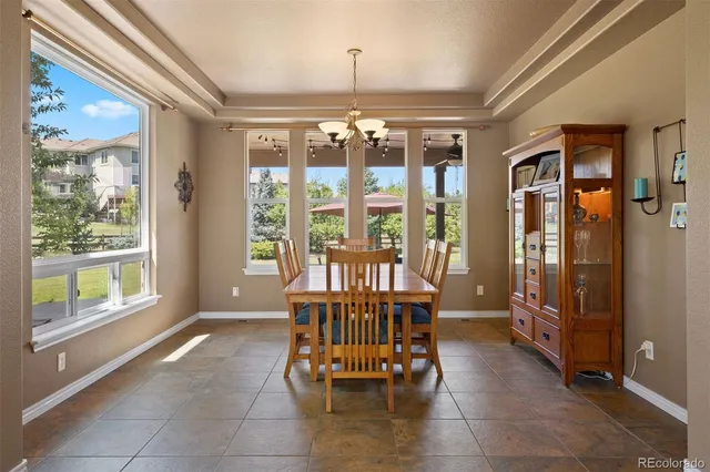 a view of a dining room with furniture large windows and wooden floor