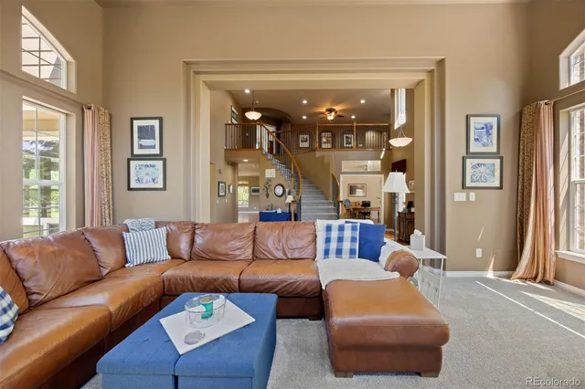 a living room with furniture and a large mirror