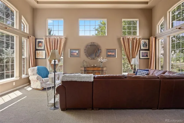 a living room with furniture and large windows