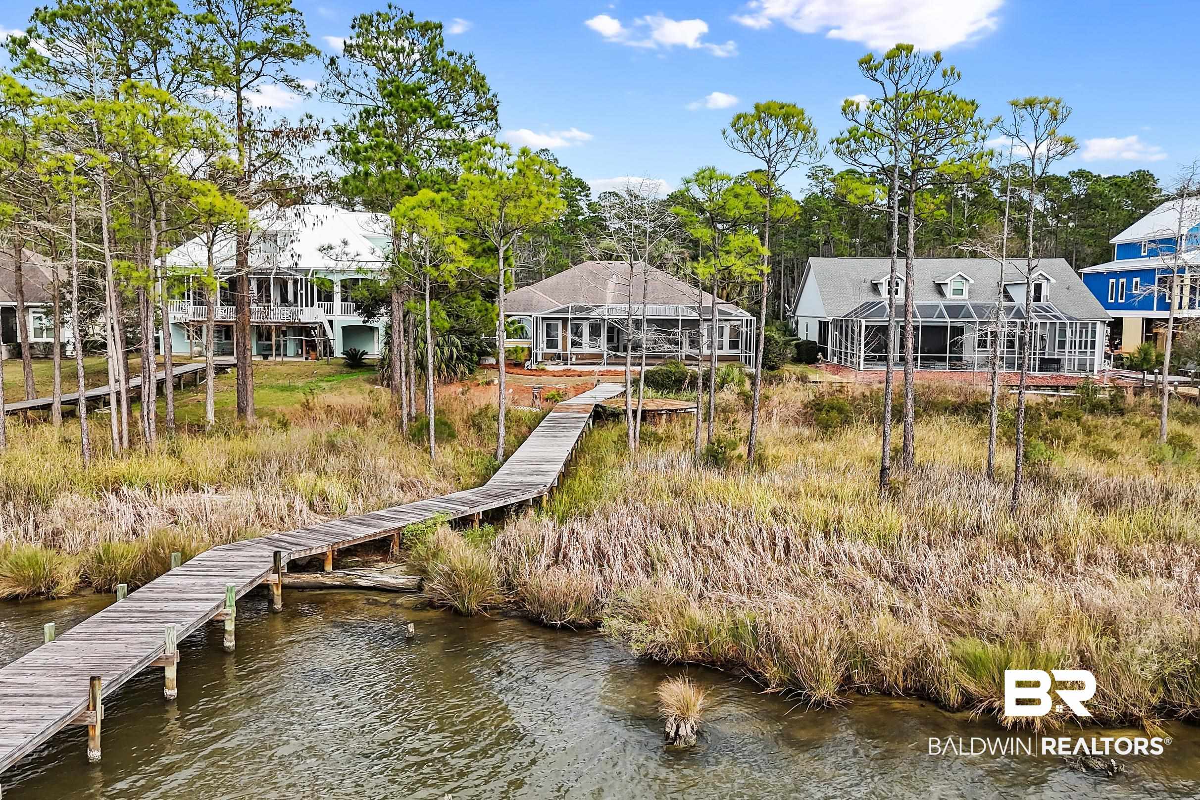 8591 Bay Harbor Road Elberta, AL 36530 - Photo 49 of 56 Dock area featuring a water view, a residential view, and view of wooded area