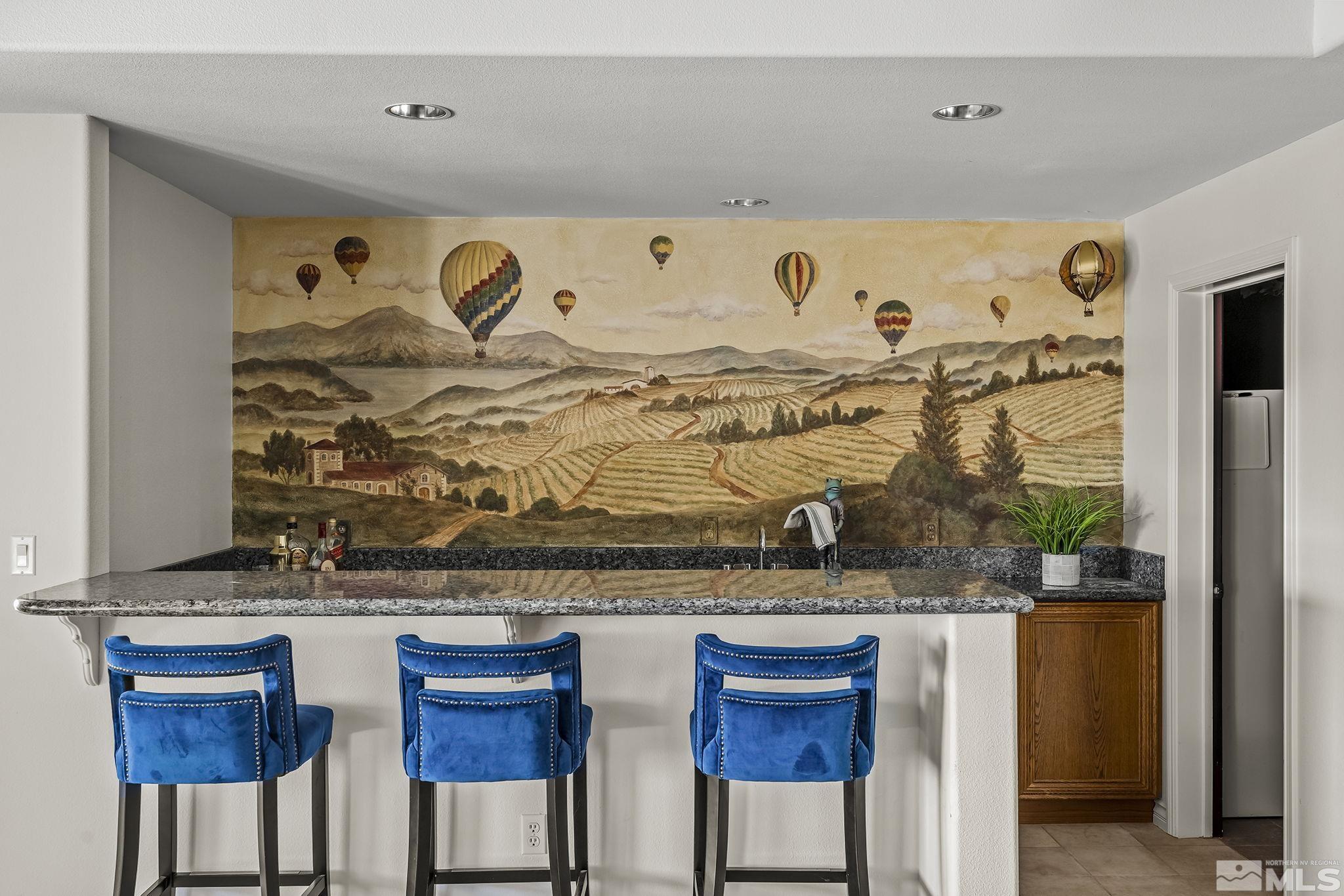 8755 Eaglenest Road Sparks, NV 89436 - Photo 12 of 40 a table with chairs and painting on a wall