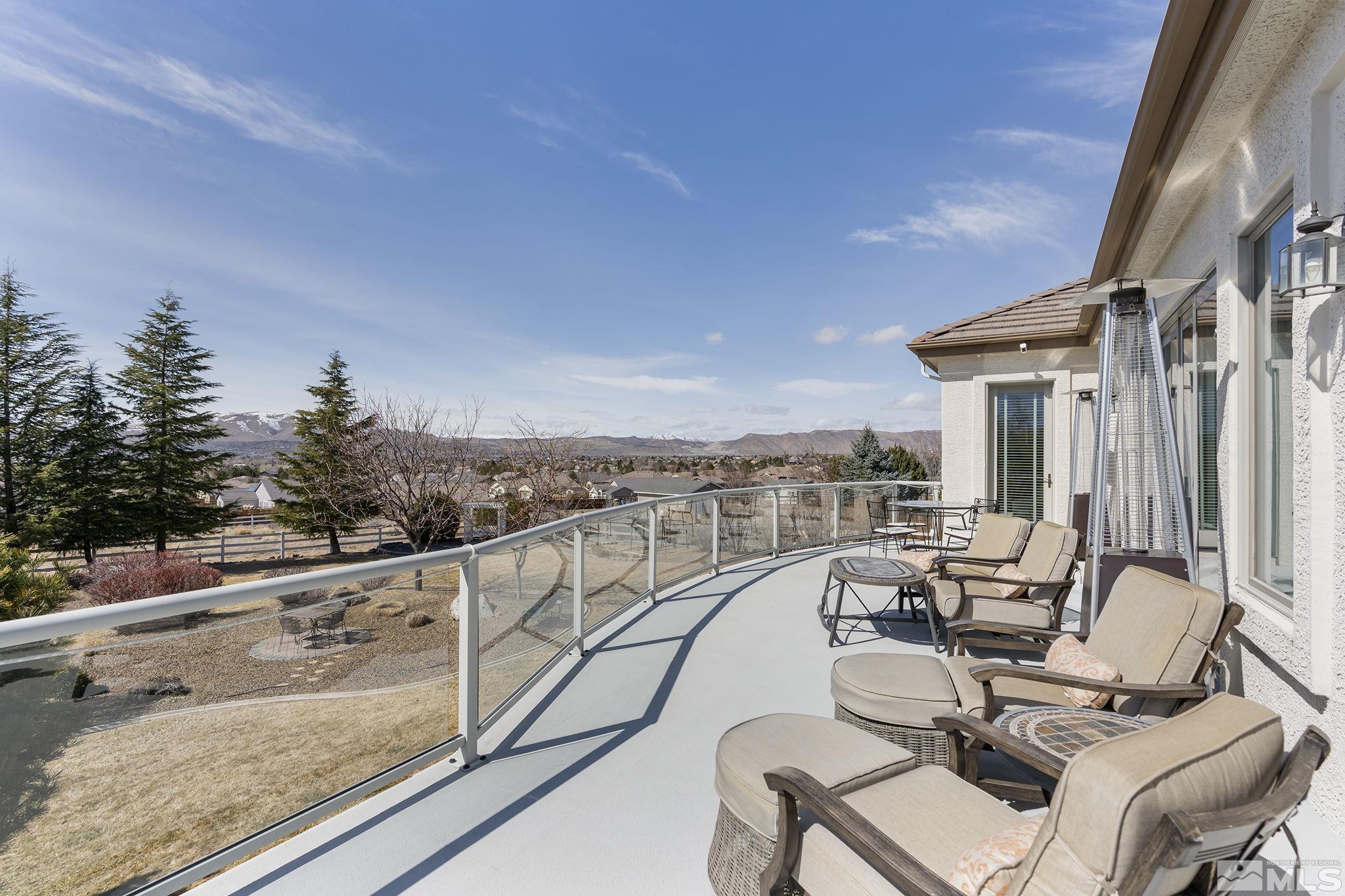 8755 Eaglenest Road Sparks, NV 89436 - Photo 38 of 40 a view of a patio with couches chairs and wooden floor