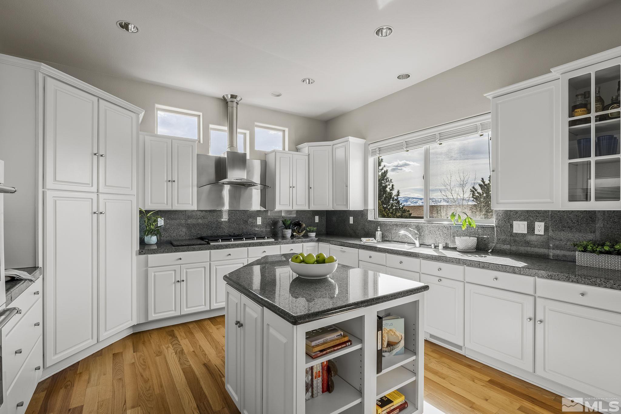 8755 Eaglenest Road Sparks, NV 89436 - Photo 5 of 40 a kitchen with granite countertop a sink stove and cabinets