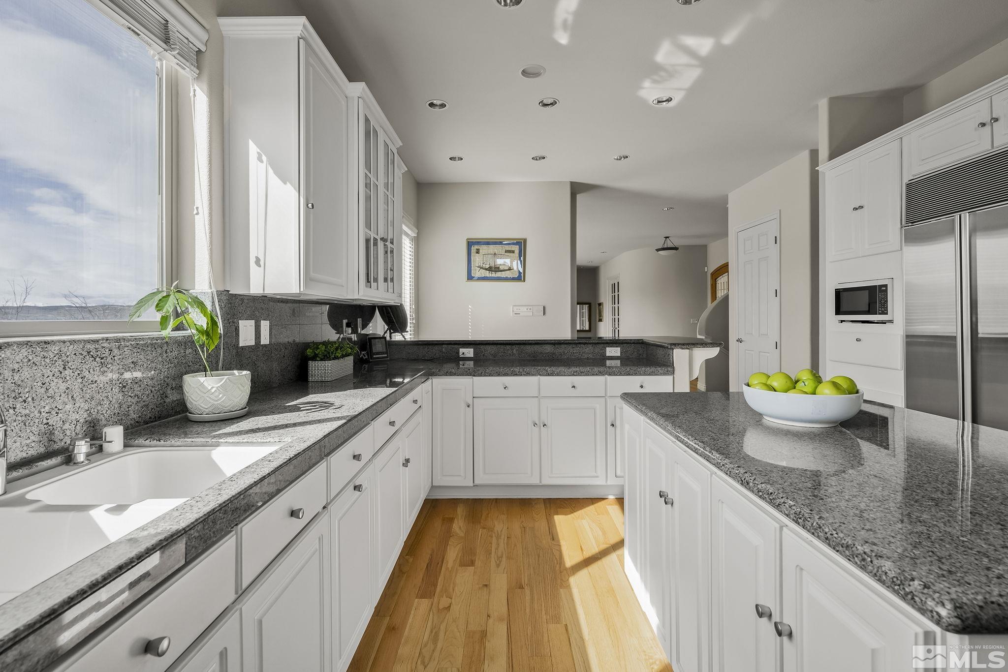 8755 Eaglenest Road Sparks, NV 89436 - Photo 6 of 40 a kitchen with sink a stove and cabinets