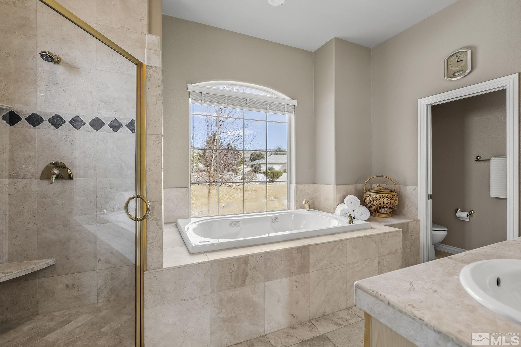 8755 Eaglenest Road Sparks, NV 89436 - Photo 8 of 40 a bath tub sitting next to a bathroom sink