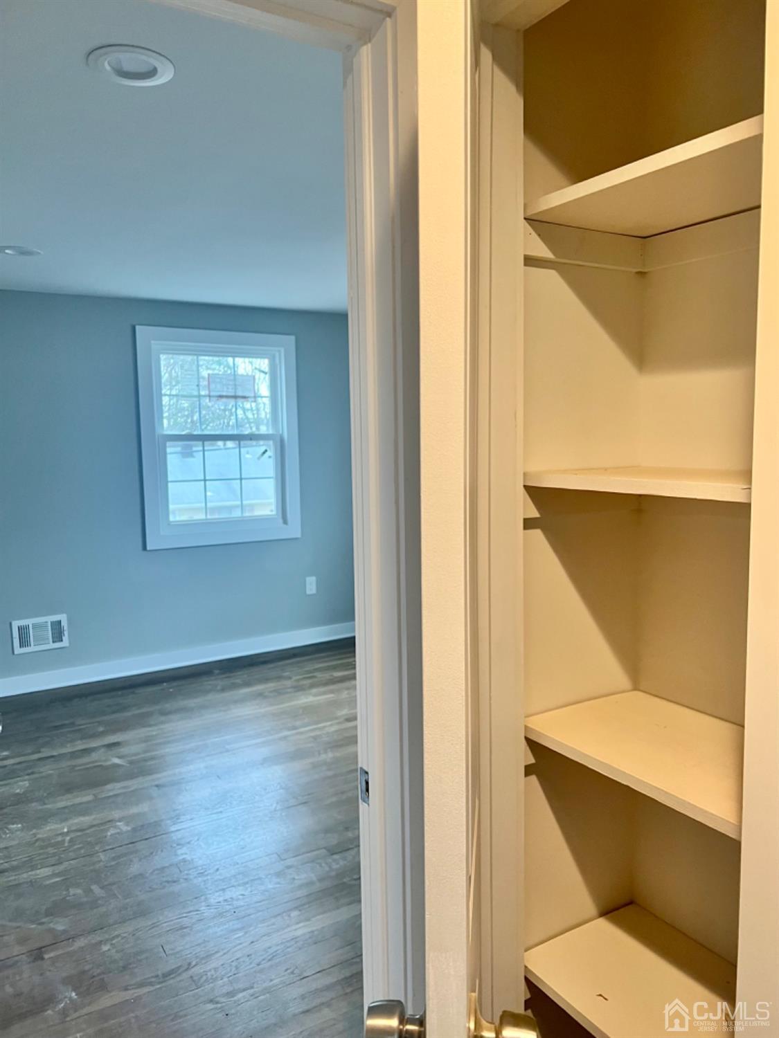 405 Crows Mill Road Fords, NJ 08863 - Photo 12 of 20 a view of an empty room with wooden floor and a window