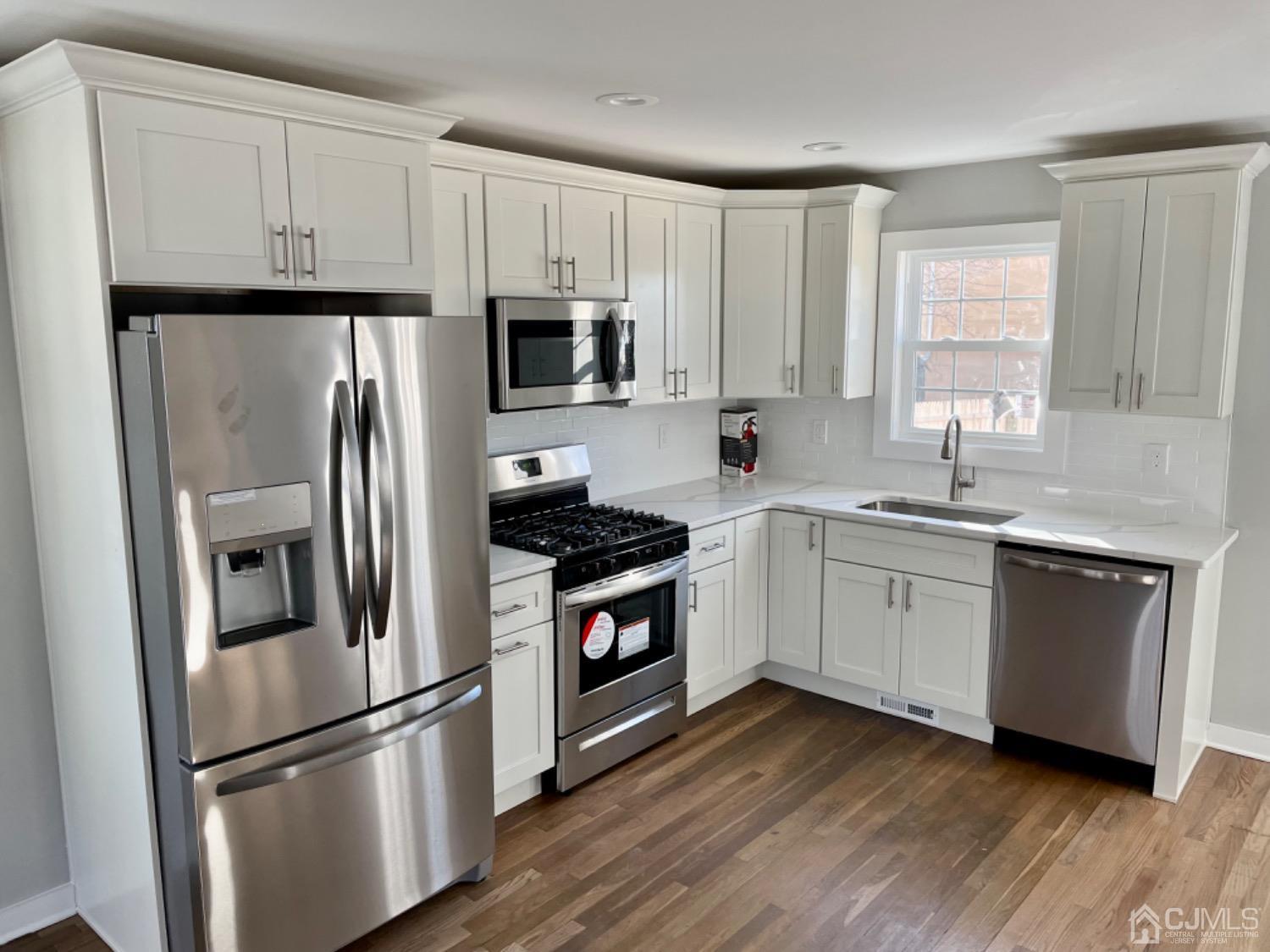 405 Crows Mill Road Fords, NJ 08863 - Photo 3 of 20 a kitchen with cabinets stainless steel appliances a sink and a window