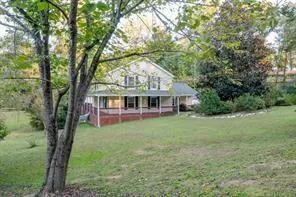 a view of house with outdoor space and garden