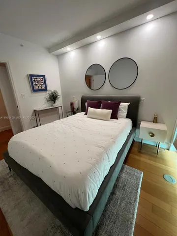 a bedroom with bed and a window