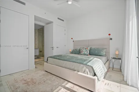 a bedroom with a bed and a mirror