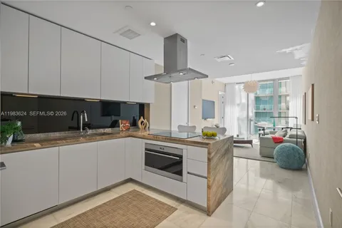 a kitchen with stainless steel appliances granite countertop a sink and cabinets