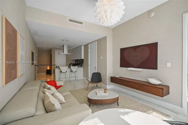 a living room with furniture and a chandelier
