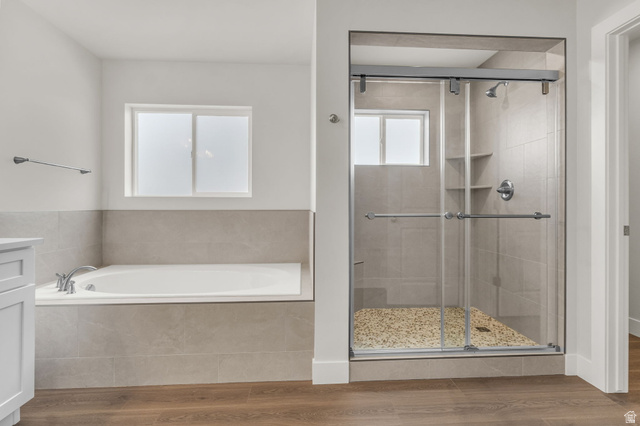 576 7th Avenue Midvale, UT 84047 - Photo 13 of 32 Full bathroom featuring vanity, a bath, wood finished floors, and a shower stall