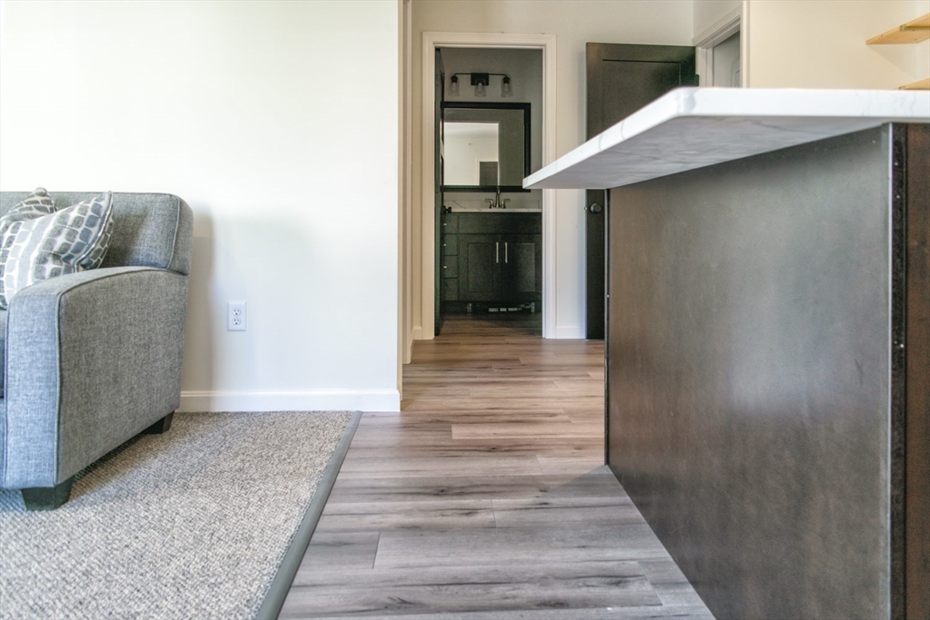 49 Center Street Barnstable, MA 02601 - Photo 19 of 36 a hallway with stairs and a couch