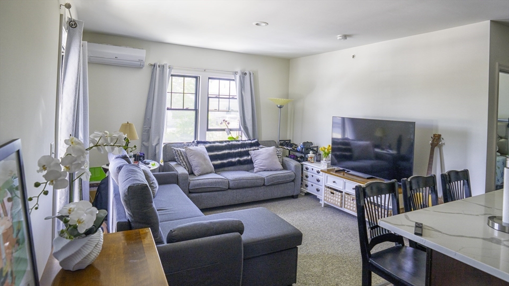 49 Center Street Barnstable, MA 02601 - Photo 20 of 36 a living room with furniture a flat screen tv and a window