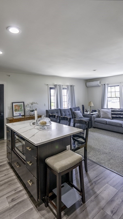 49 Center Street Barnstable, MA 02601 - Photo 21 of 36 a room with a table chairs and a kitchen