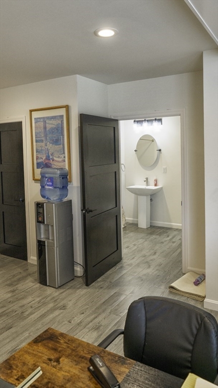 49 Center Street Barnstable, MA 02601 - Photo 23 of 36 a living room with stainless steel appliances kitchen island granite countertop a refrigerator and a sink
