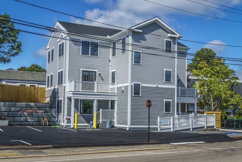 49 Center Street Barnstable, MA 02601 - Photo 3 of 36 a front view of a house with a yard