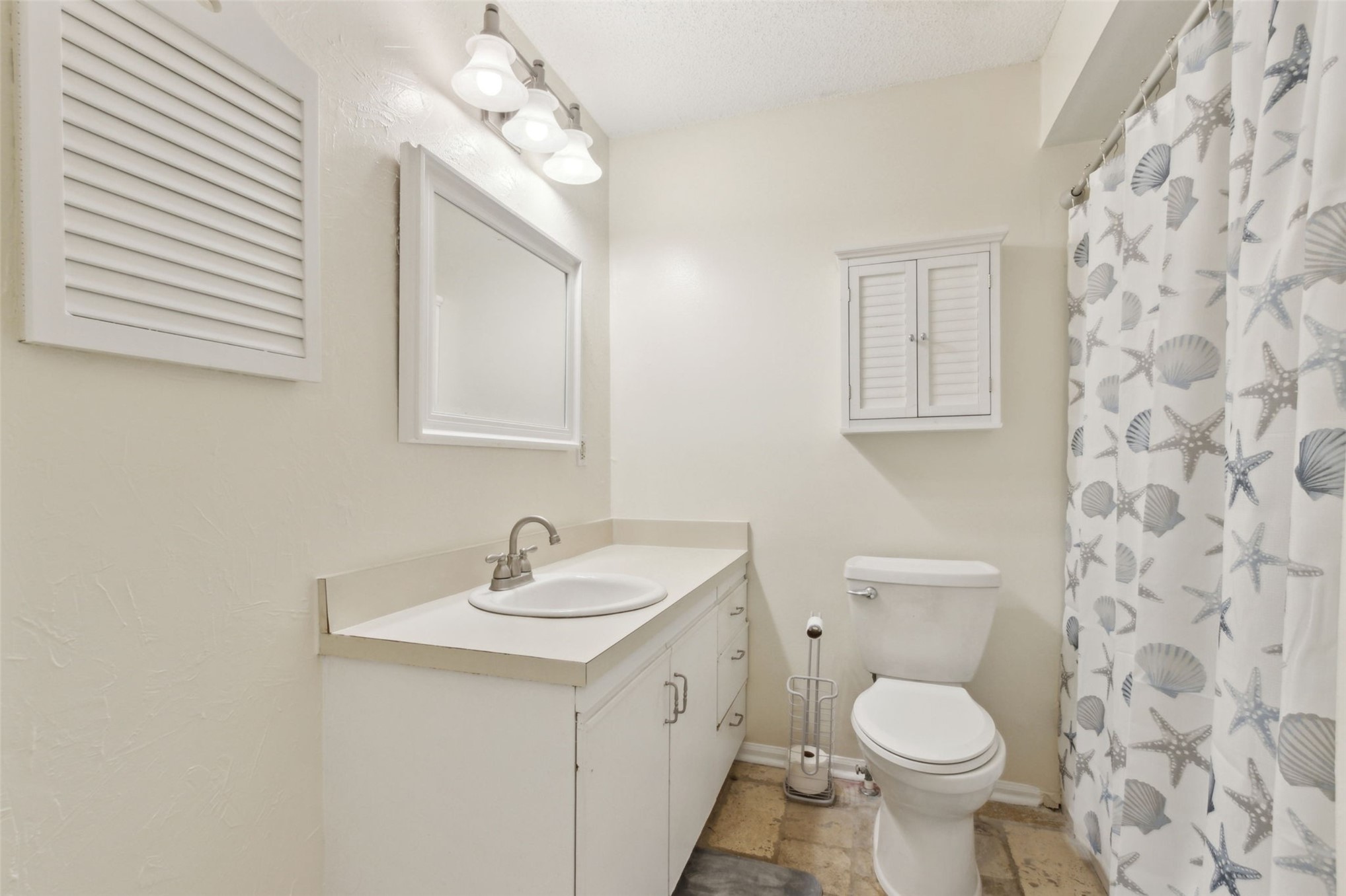 2583 Forest Ridge Drive, Unit N3 Fernandina Beach, FL 32034 - Photo 24 of 34 a bathroom with a toilet a sink a mirror a window and vanity