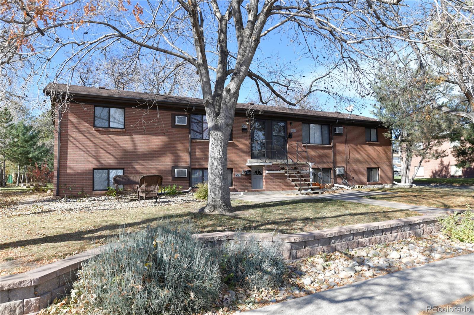 4563 Everett Street Wheat Ridge, CO 80033 - Photo 2 of 10 a view of a house with a yard covered with snow