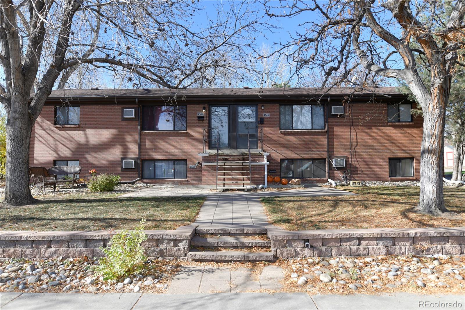 4563 Everett Street Wheat Ridge, CO 80033 - Photo 7 of 10 a front view of a house with a yard